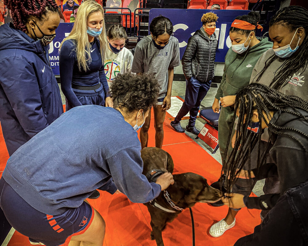 K9 Winston visits with the Fighting Illini women's basketball team in January 2021.