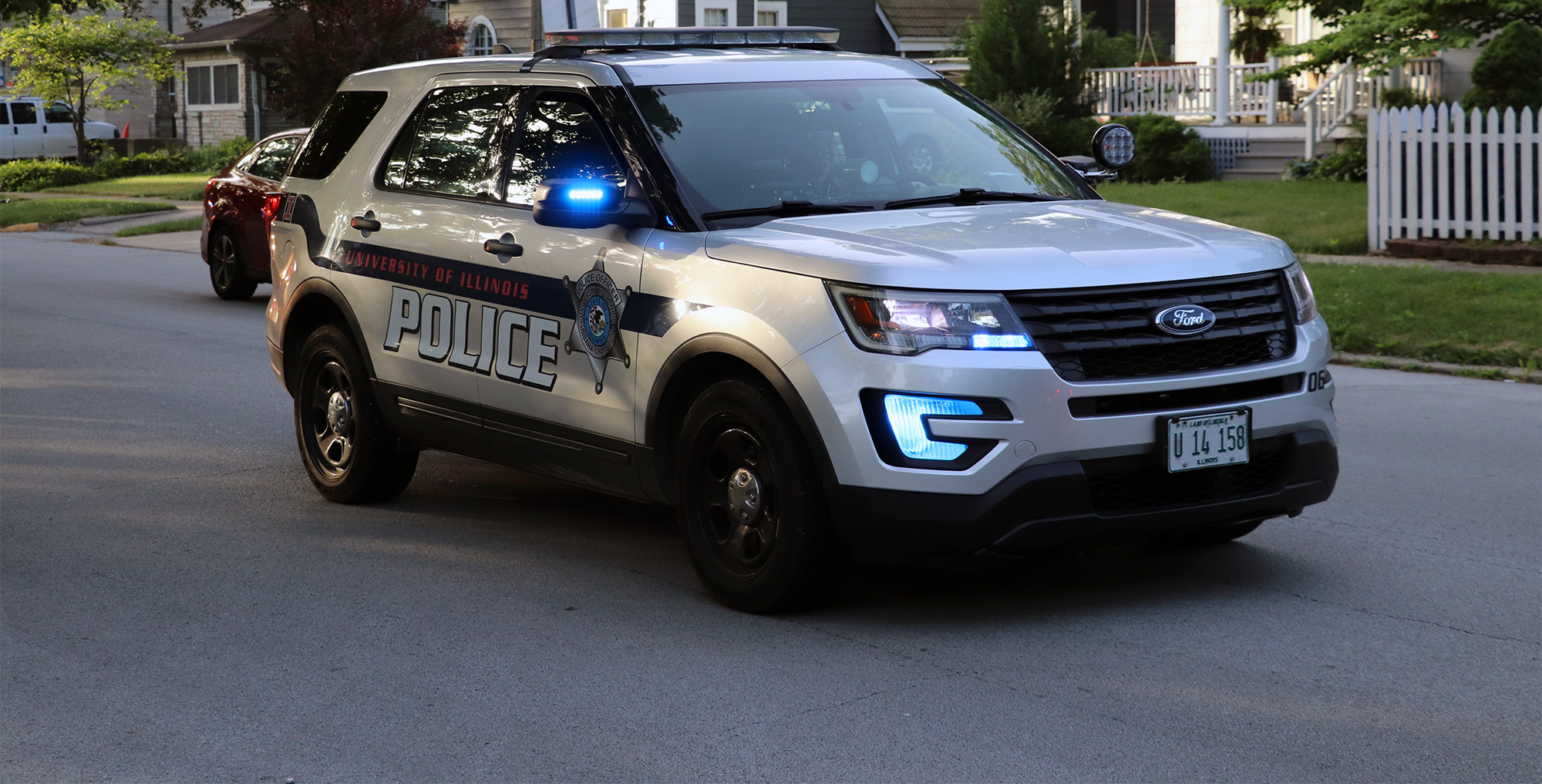 A UIPD patrol vehicle on the street in a residential neighborhood