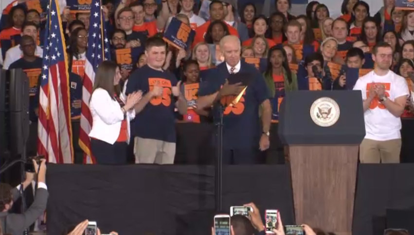 Vice President Joe Biden puts on an It's On Us T-shirt presented by the Illinois Student Senate.