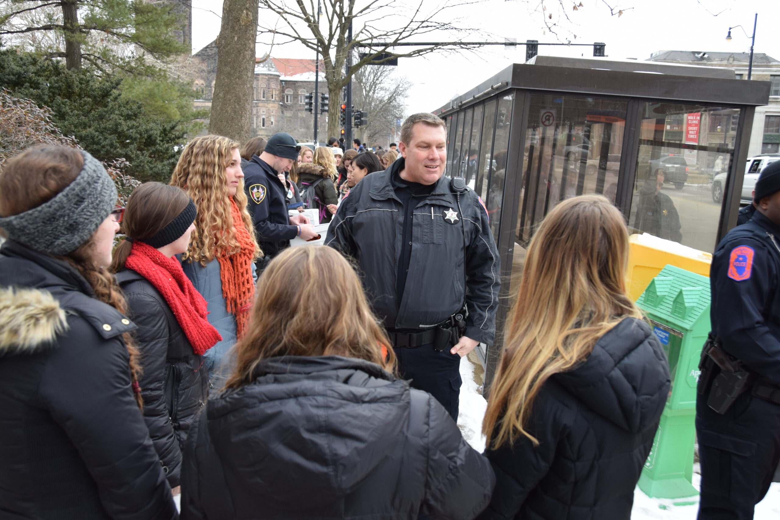 Detective Gene Moore speaks with students during a Walk As One event in 2015, when police and students joined forces to deliver important safety information to campus community members.