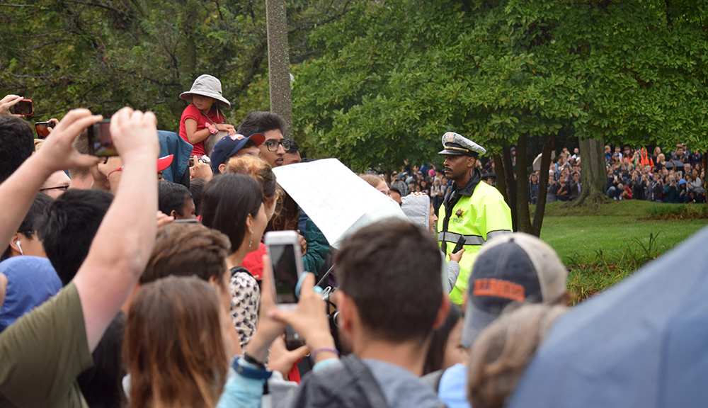 Sergeant James Carter standing watch over a large, cheerful crowd during former President Barack Obama's visit to campus in fall 2018.