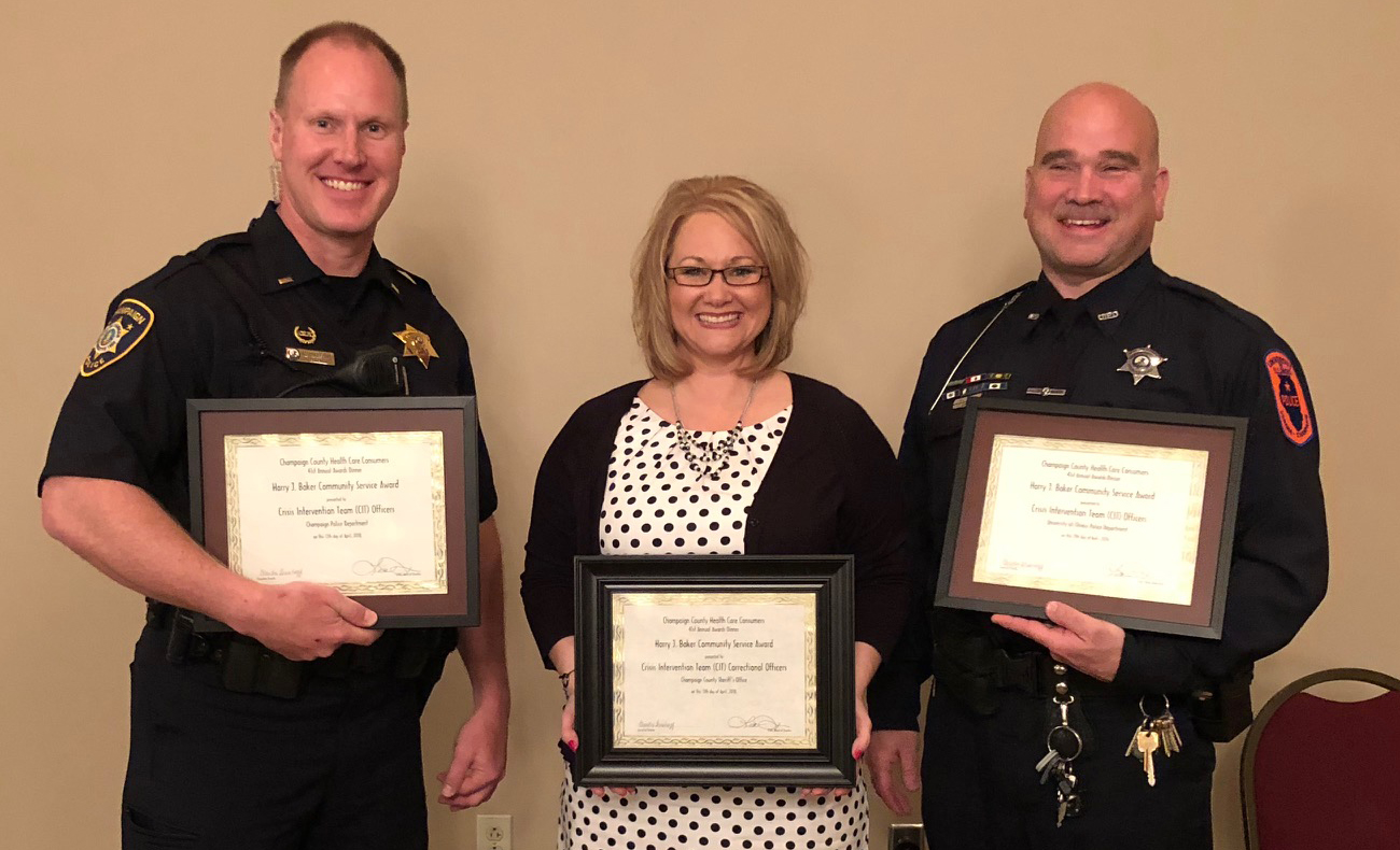 Champaign Police Lt. Mark Vogelzang, Champaign County Sheriff's Captain Karee Voges and U. of I. Police Officer Brian Tison accept the Harry J. Baker Community Service award on behalf of the county's crisis intervention team.