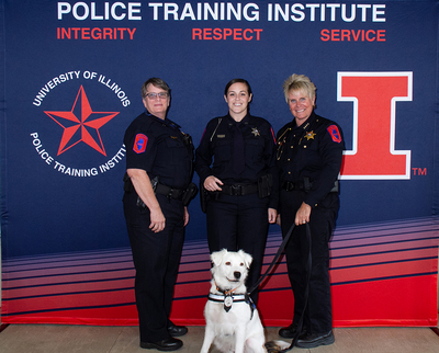 Lt. Barb Robbins (left), Officer Valerie Marcotte (center), Police Chief Alice Cary (right) and law enforcement therapy K-9 Archie.