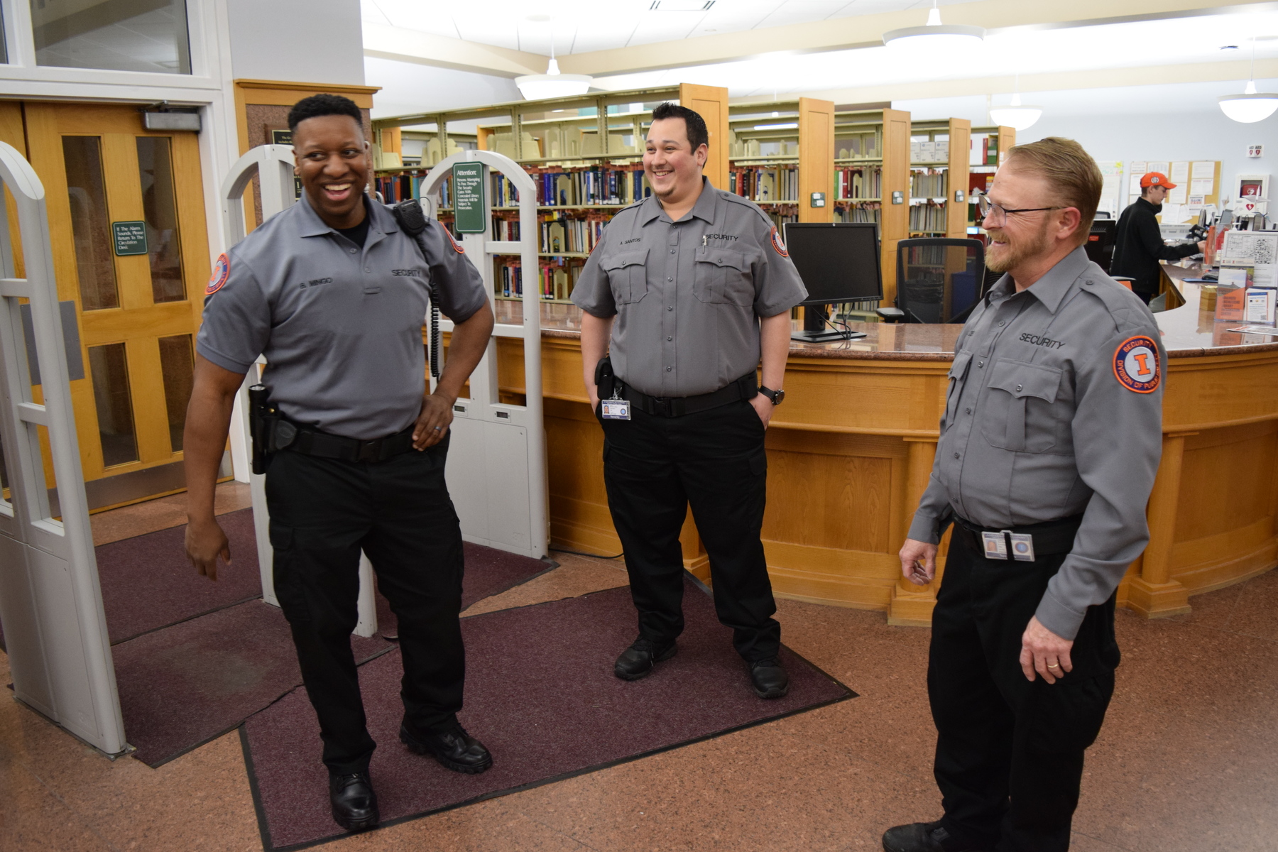 Security Guards Ben Mingo, Alfredo Santos and Brett Doney patrol Grainger Engineering Library.