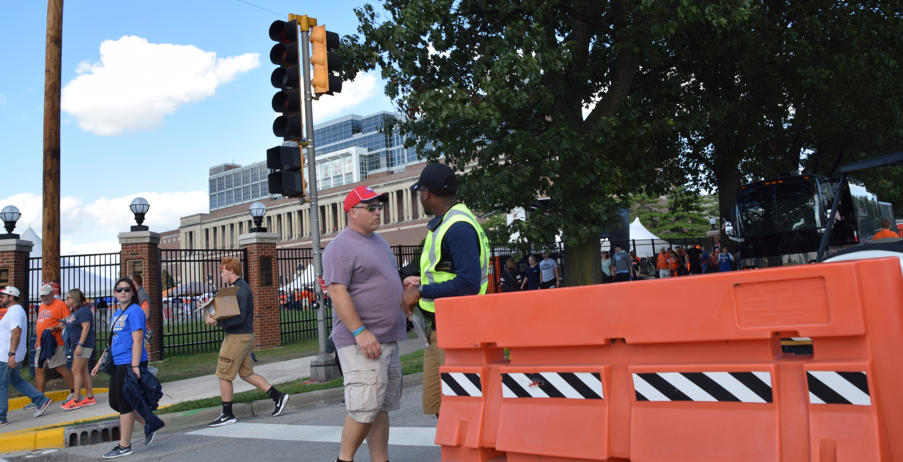 A U. of I. Student Patrol Officer speaks with a football fan outside of Memorial Stadium.